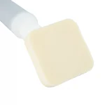 Close-up of a white pump bottle with a beige makeup sponge resting nearby on a white background.CHG Applicator (26mL, 30mL, 35mL & 40mL)
